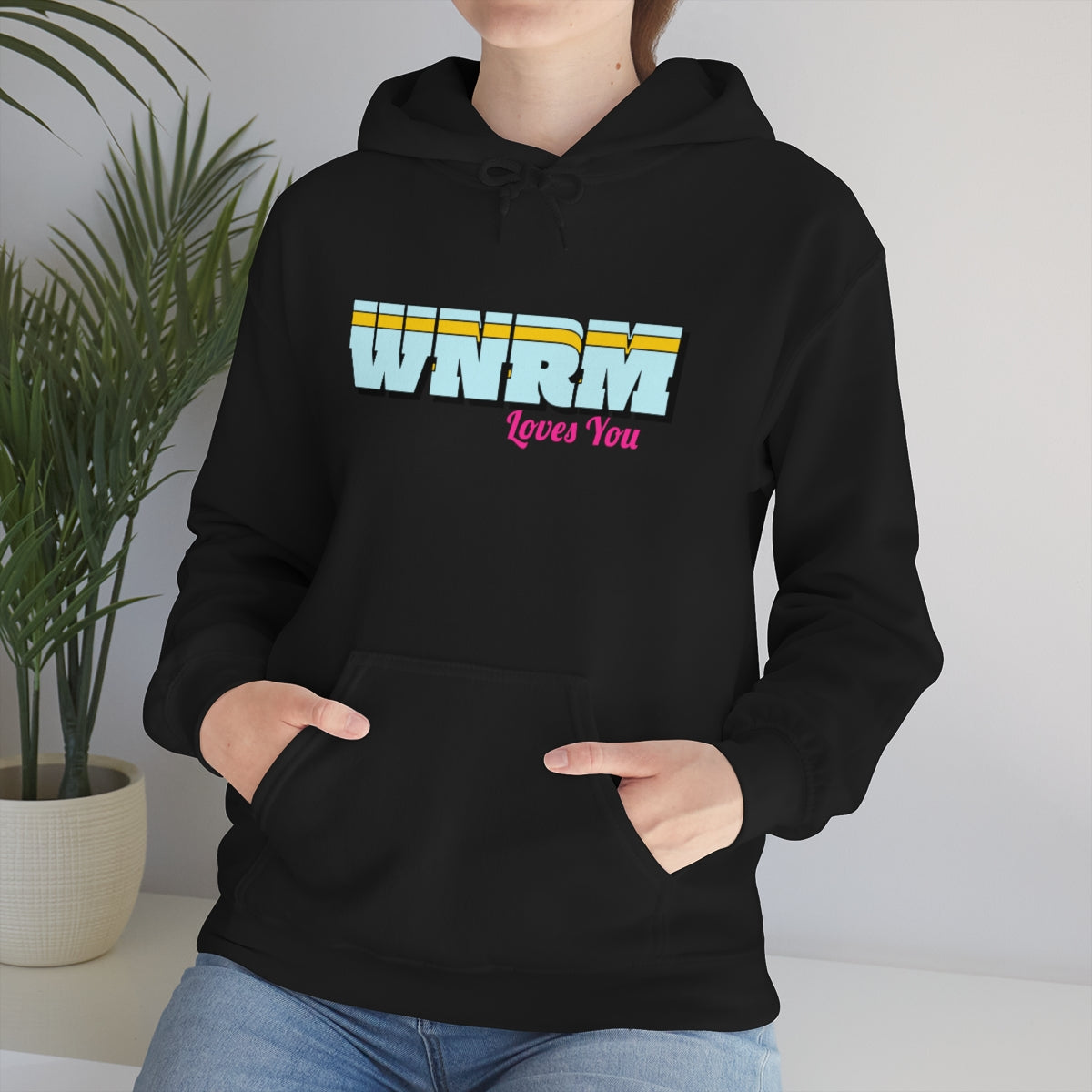 Woman wearing a WNRM Loves You Unisex Heavy Blend™ Hooded Sweatshirt