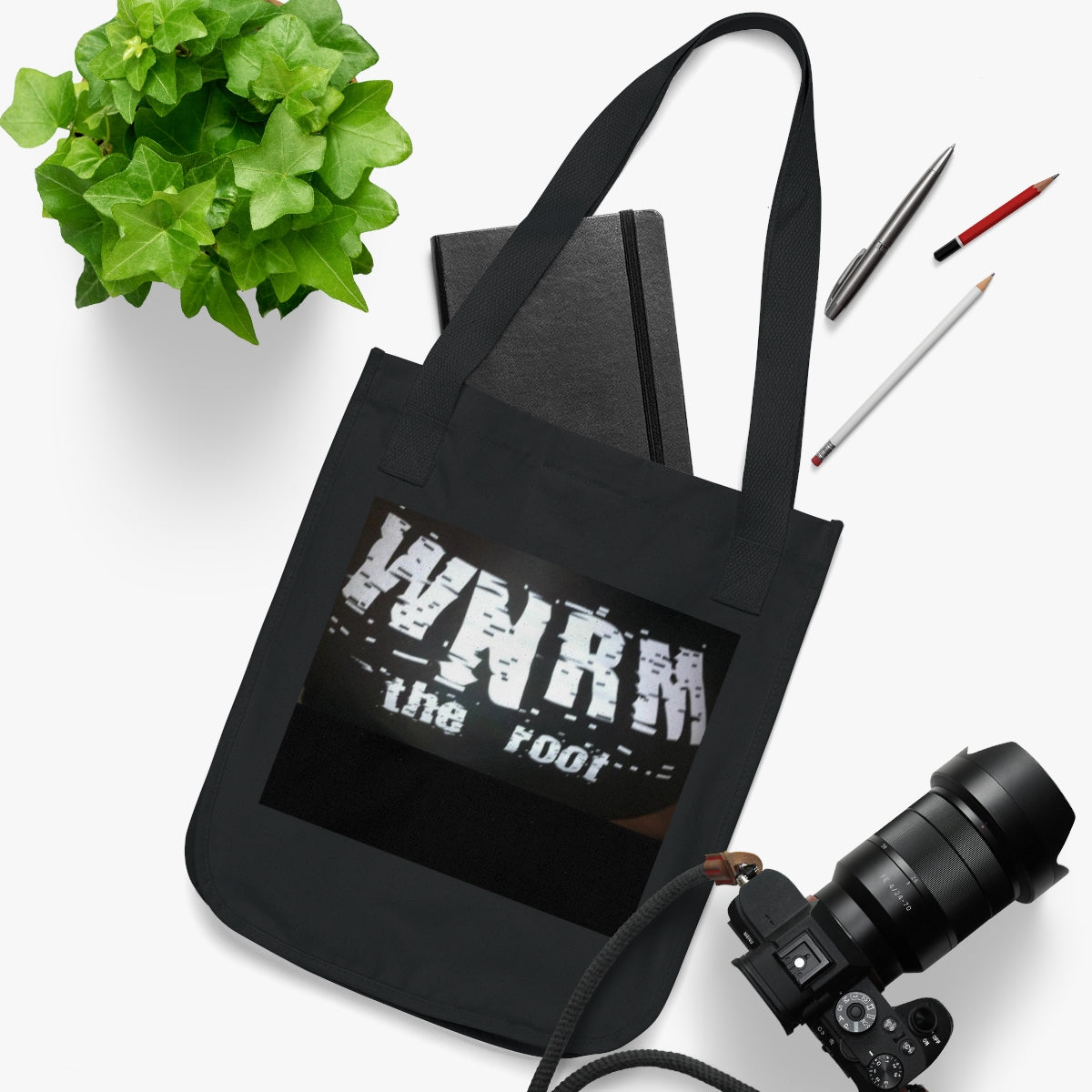 OG WNRM Boobs Bag Organic Canvas Tote Bag with a camera and a plant  and pencils