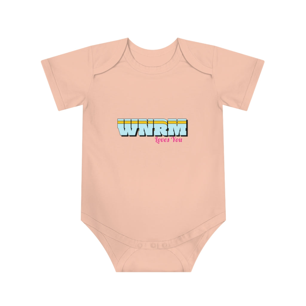 Cute baby with hands on heads wearing a WNRM Loves You Baby Short Sleeve Bodysuit pink, with a white background