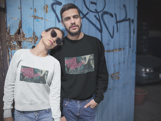 Cool, good looking couple wearing WWW Unisex Heavy Blend™ Crewneck Sweatshirt in front of graffiti 