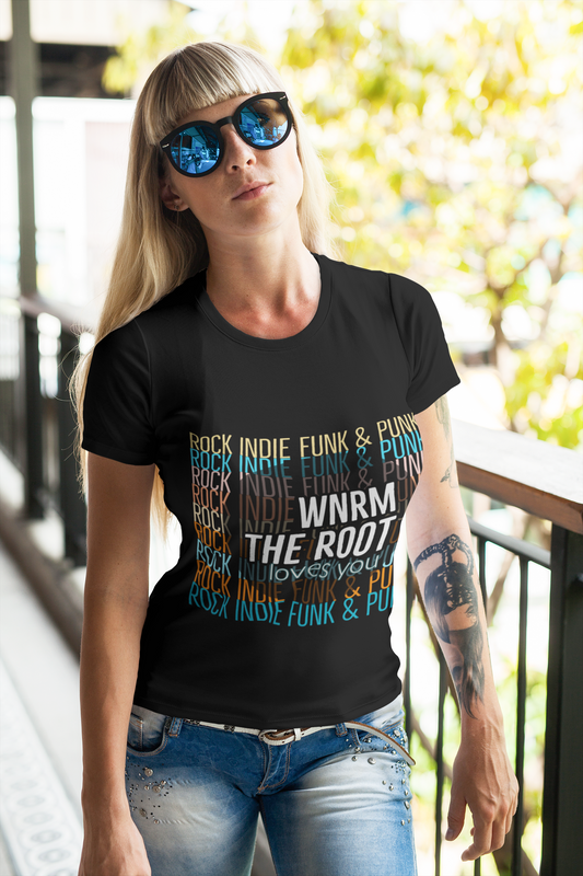 Pretty, slim, blonde woman wearing a black WNRM Loves You colors tee on the balcony on a sunny day