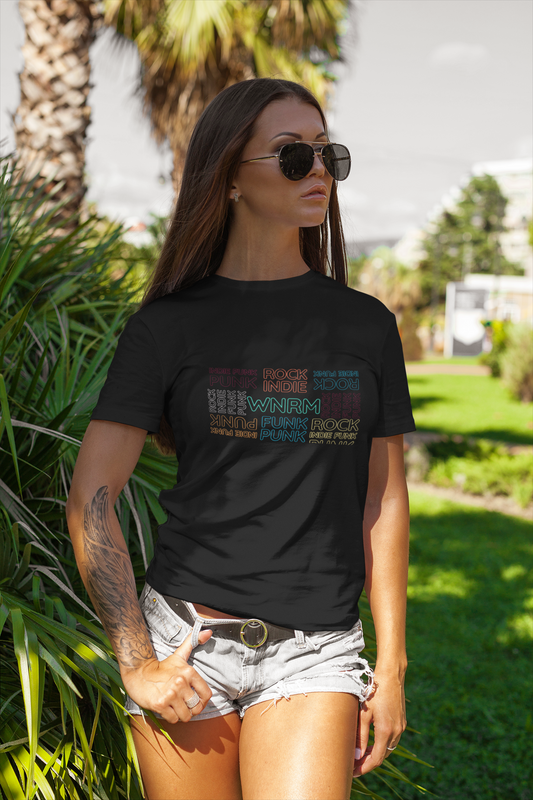Cool, pretty woman wearing a WNRM Neon Block Tee, outside on the grass by palm trees